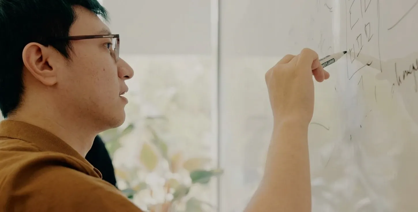 Sony Nguyen, founder of NYSS, sketching a solution on a whiteboard